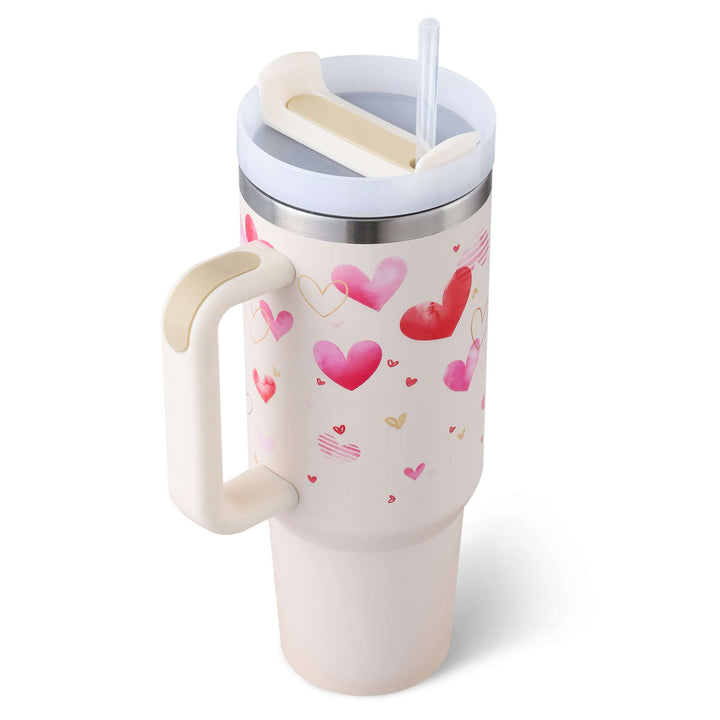 40 Oz insulated stainless steel tumbler with handle and straw, adorned with heart patterns, ideal for coffee or tea on-the-go.