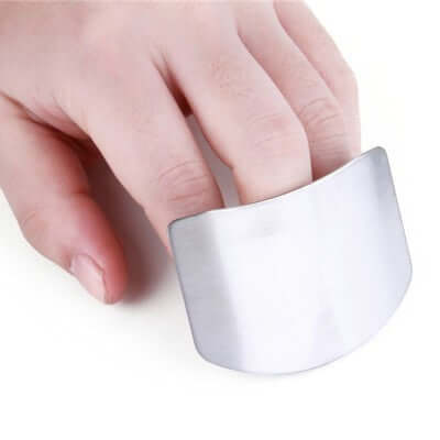 Stainless steel finger guard for safe slicing and chopping, perfect for modern kitchens and culinary tasks.