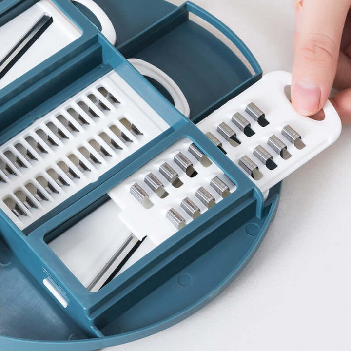 Close-up of Kitchen Multifunctional Vegetable Shredder with stainless iron blades and teal design, perfect for efficient meal prep.