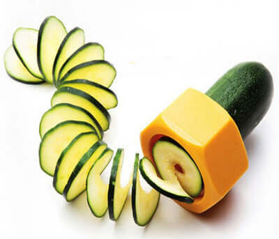 Spiral Knife Vegetable Cutter creating cucumber slices for stylish salads and garnishes. Ideal for kitchen renovation and modern cooking.