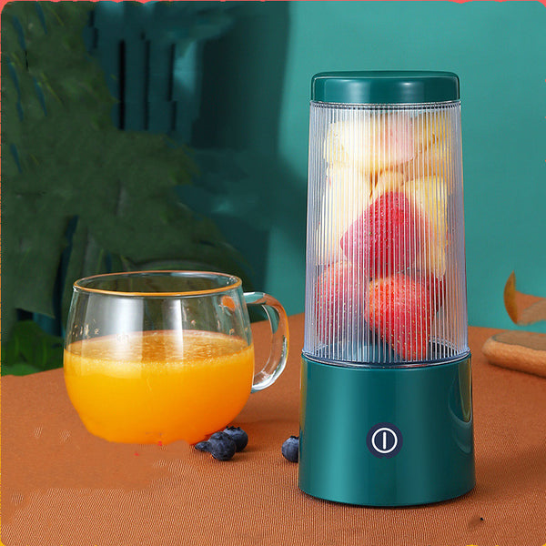 Rechargeable Portable Juicer Cup with fruit and glass of orange juice on a table.