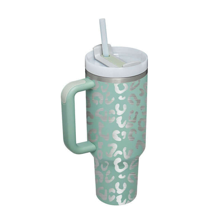 Mint green 40 Oz insulated tumbler with handle and straw, leopard print design. Ideal for gardening or home decor enthusiasts. Spill-proof.