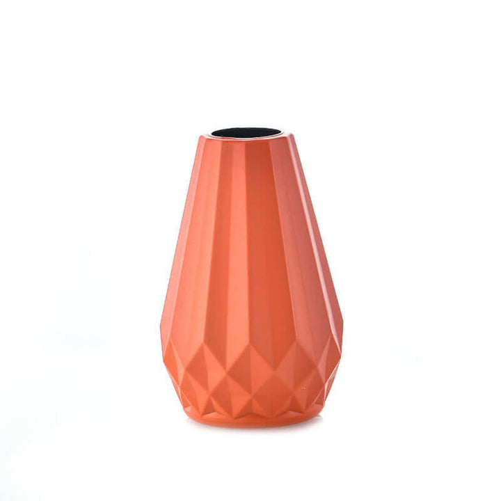 Nordic style orange plastic vase with geometric design, perfect for modern decor and sustainable home aesthetics.