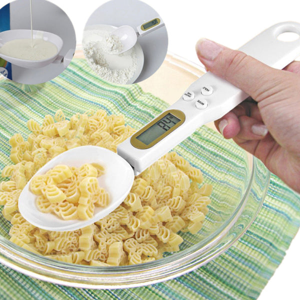 LCD digital kitchen scale measuring spoon weighing pasta in a glass bowl for precise cooking measurements.