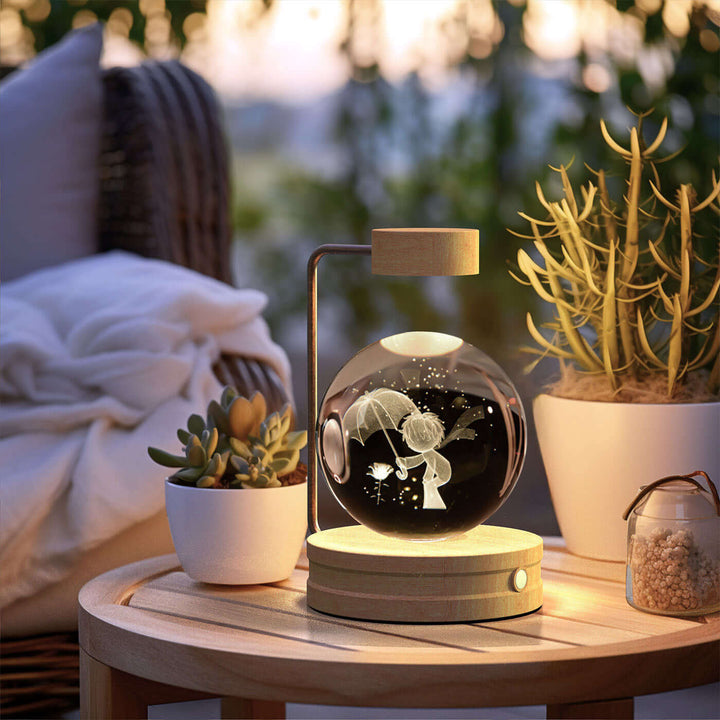 Crystal Ball Night Light with 3D design on a wooden table, surrounded by plants, creating a cozy Japandi-style ambiance.