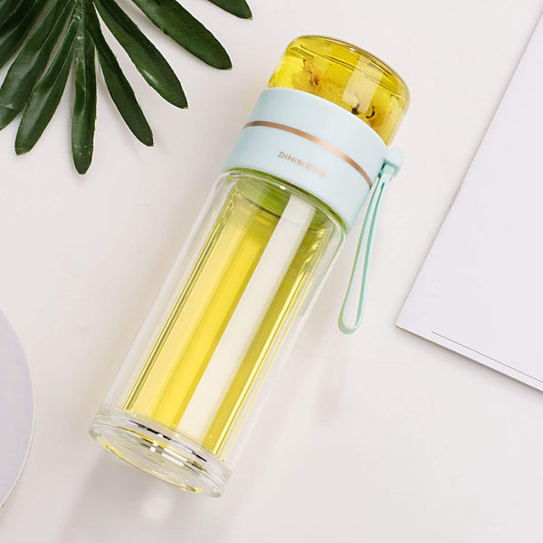 Glass water bottle with green tea infuser, double wall design for hot and cold drinks, ideal for sustainable living.