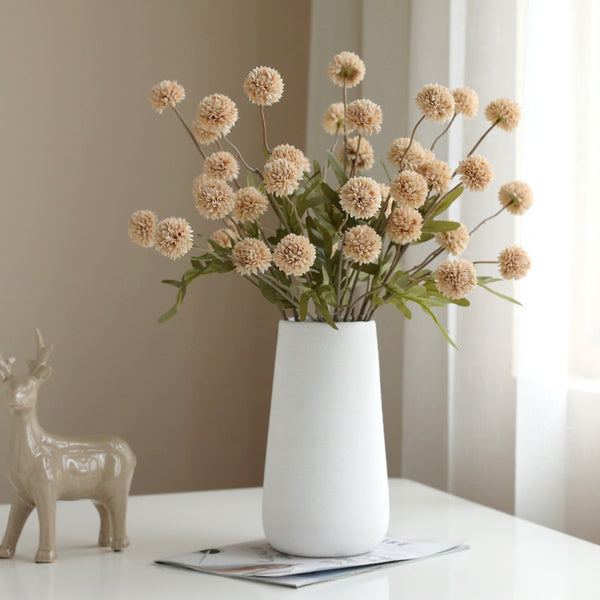 Elegant dandelion flower ornaments in a white vase for Japandi style decor, adding a biophilic touch to living spaces and weddings.