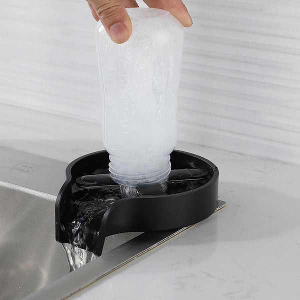 Person using a compact cup washer for sink to clean a glass, ideal for home bar counters and efficient drinkware cleaning.