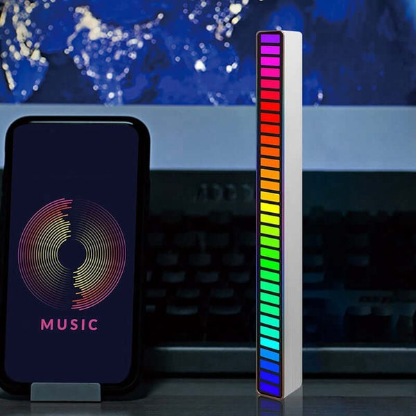 Spiral RGB Symphony decorative lamp with sound control feature reacting to music next to smartphone on a desk.