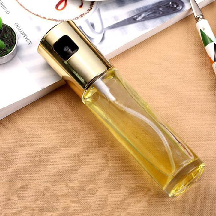 Elegant BBQ oil and vinegar spray bottle for healthy cooking, grilling, and baking with precise application on a countertop surface.