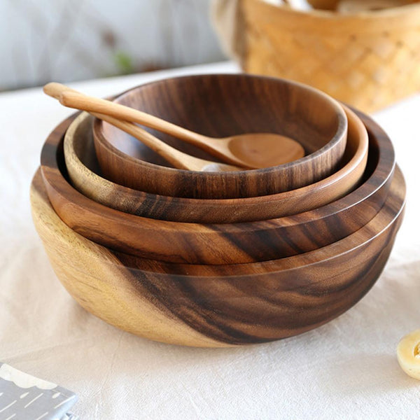 Natural wooden salad bowl set with spoon, ideal for biophilic design, Japandi style kitchens, and sustainable dining, on white cloth.