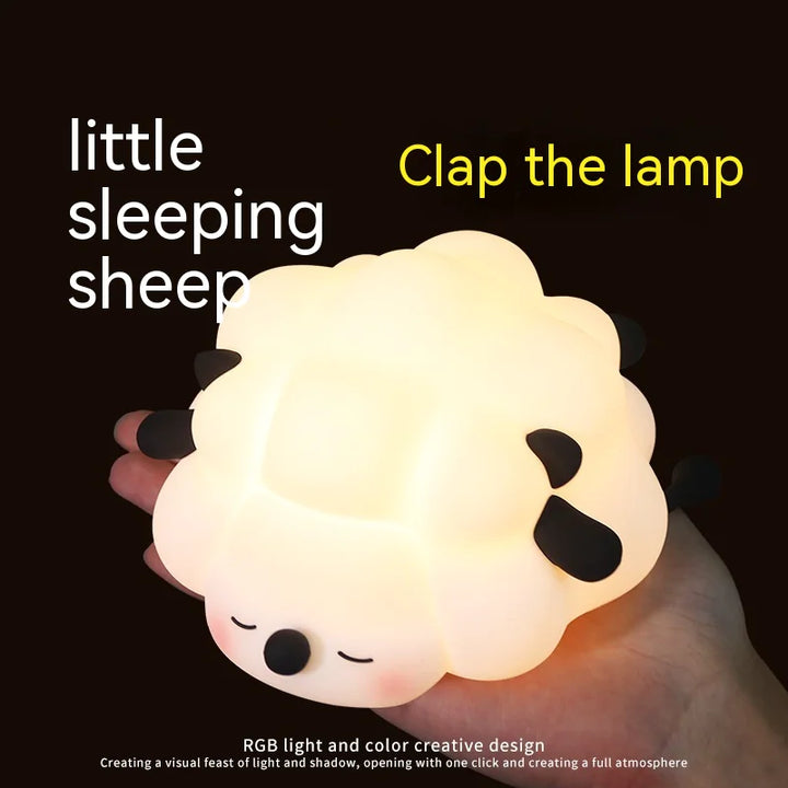 Cute sheep silicone night light being held, rechargeable and dimmable, ideal for kids' rooms with soft, safe, and squeezable design.
