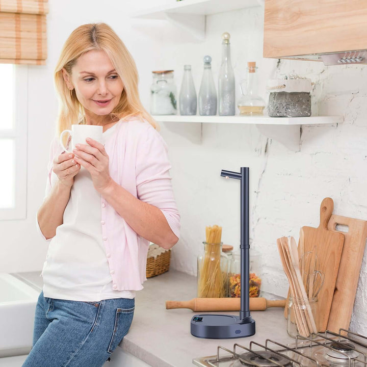 Woman enjoying a drink near an Automatic Water Dispenser on a kitchen countertop.