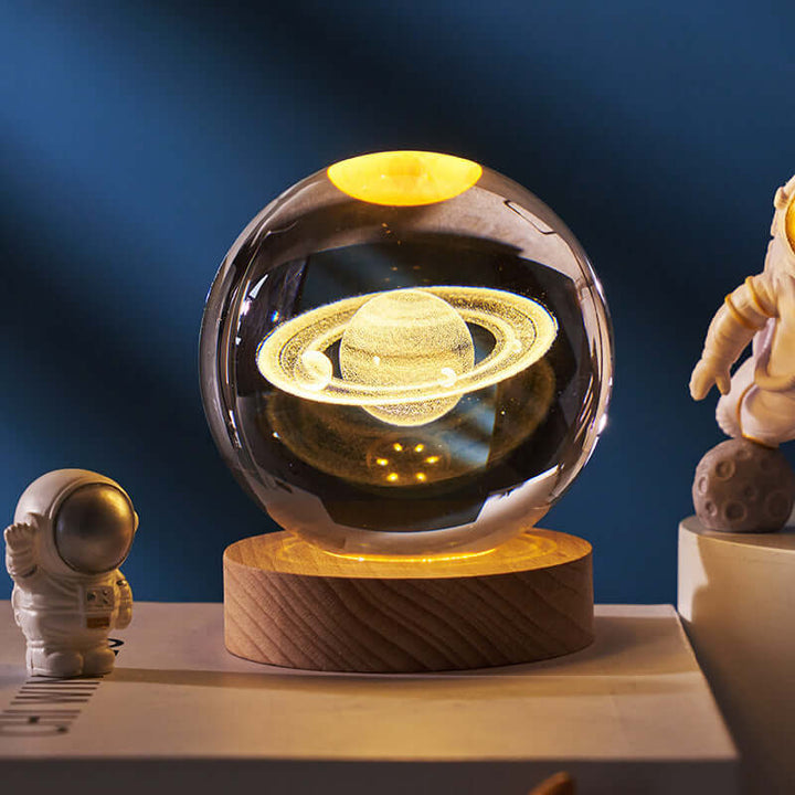 Luminous Starry Sky Crystal Ball projecting Saturn on a wooden base, perfect for ambient lighting and cosmic decor.