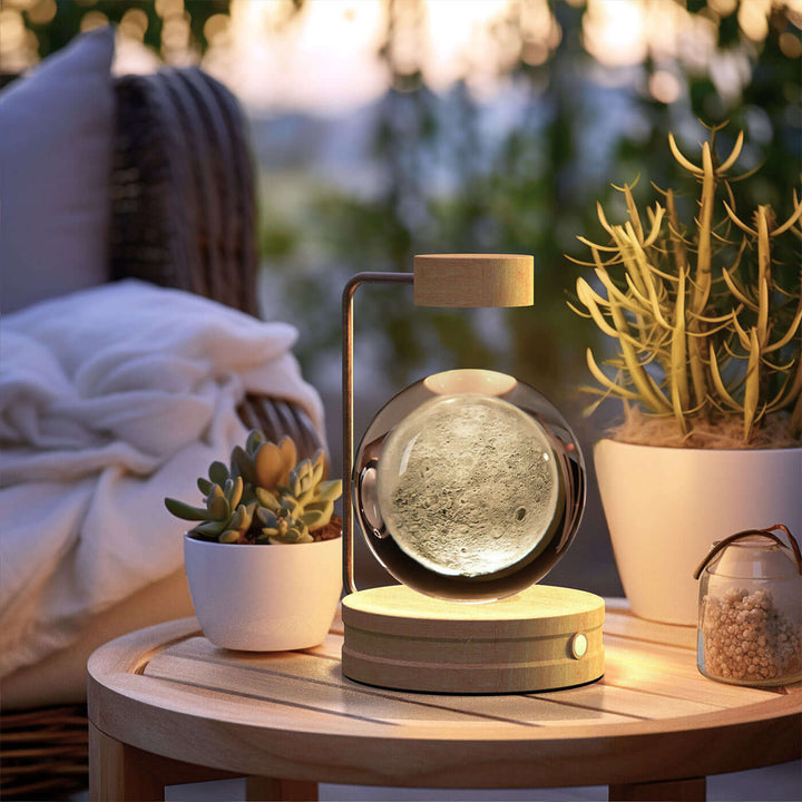 Crystal ball night light on a cozy bedside table with plants, enhancing Japandi style and cottagecore aesthetic in bedroom decor.