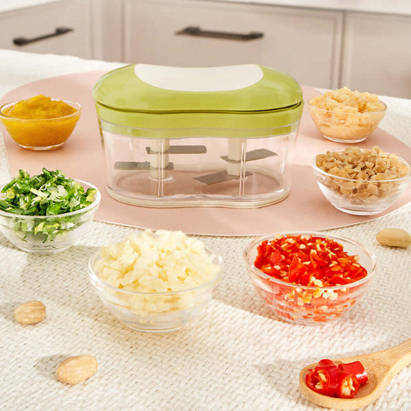 Hand Push Garlic Press on kitchen counter with chopped ingredients in bowls, showcasing efficient cutting for meal prep.