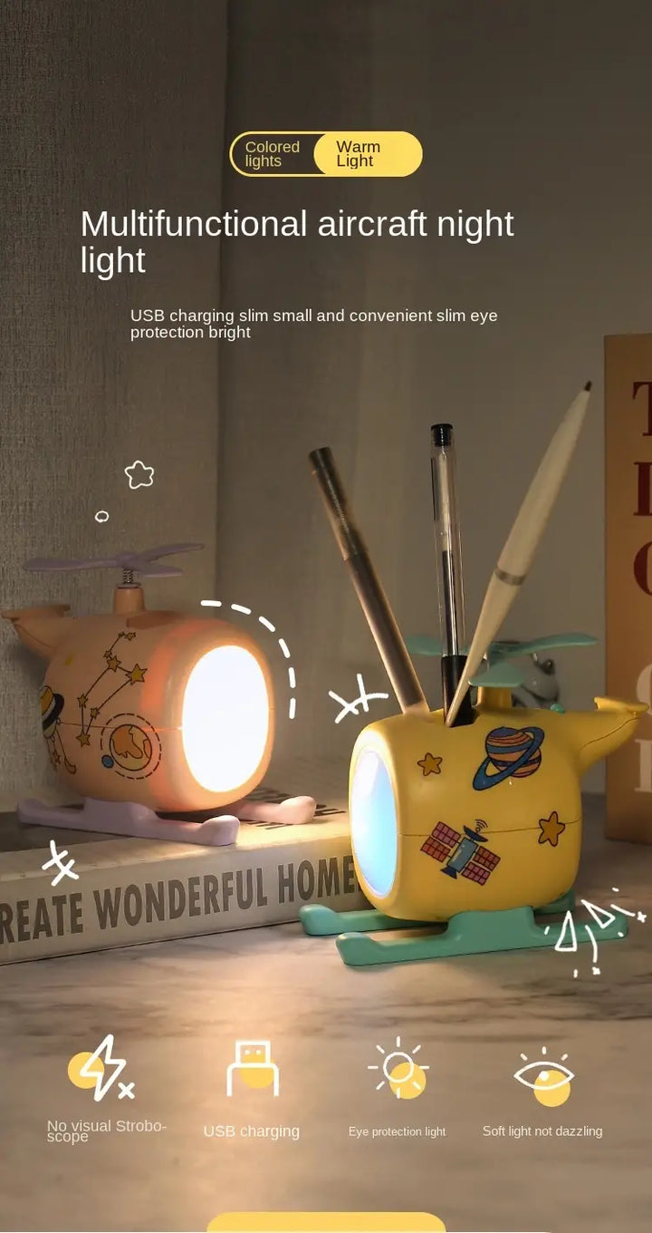 Airplane-shaped USB rechargeable LED night light on desk with pens, offering warm illumination in kids’ room or office.