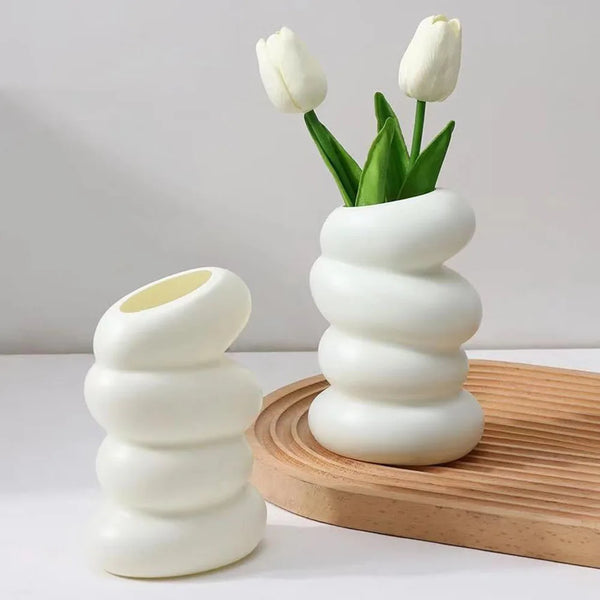 Modern white spiral plastic vase with tulips, perfect for biophilic and Japandi decor, enhancing home or office elegance.