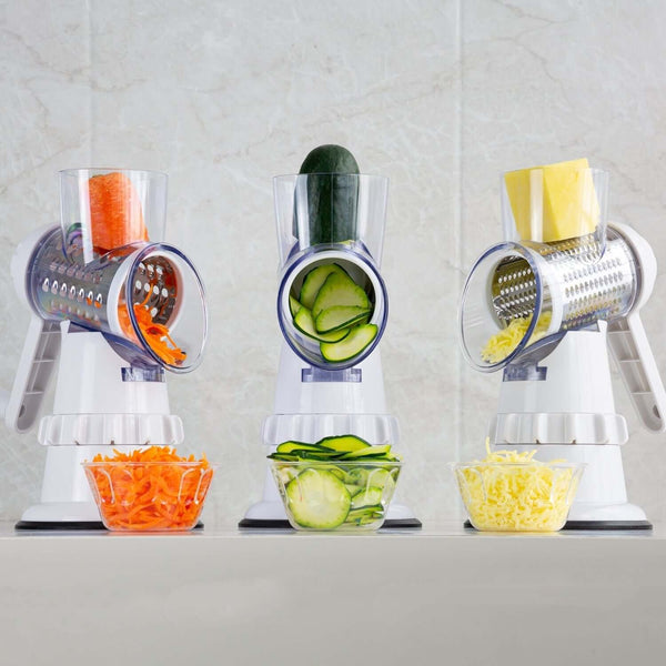 3-in-1 vegetable slicer & grater with grated carrots, zucchini slices, and cheese shreds, ideal for efficient kitchen prep.