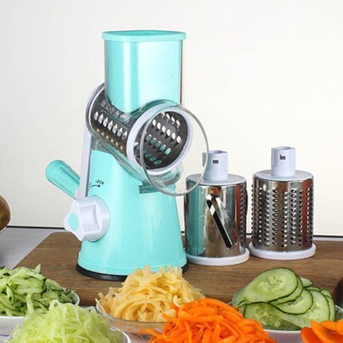 Manual Round Mandoline Slicer with assorted sliced vegetables; a multifunctional kitchen tool for grating and slicing.