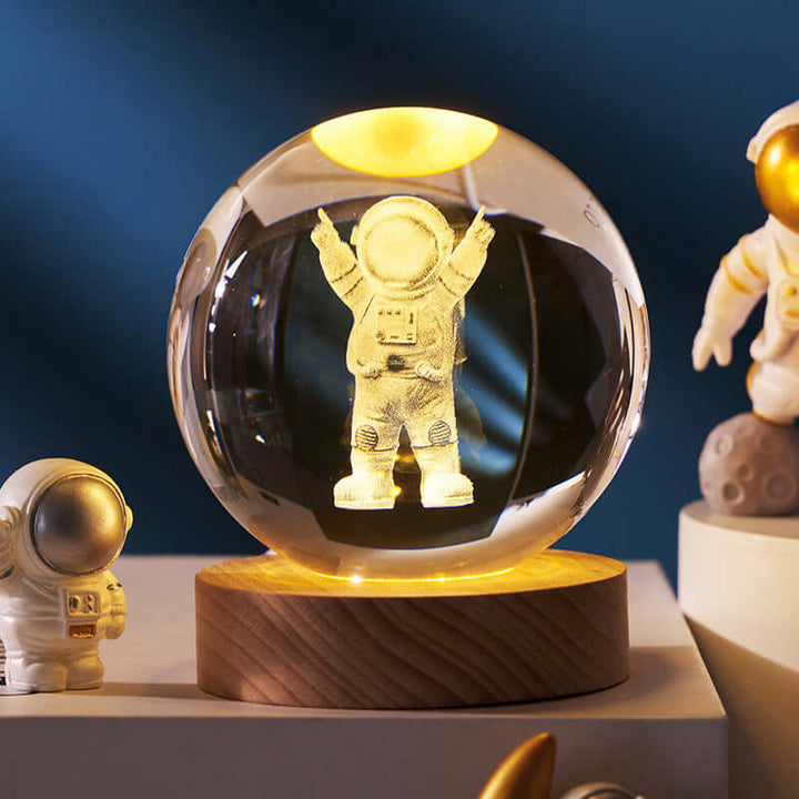 Luminous Starry Sky Crystal Ball Night Lamp with astronaut design, glowing ambiance, wooden base, and 3D planetary projection.