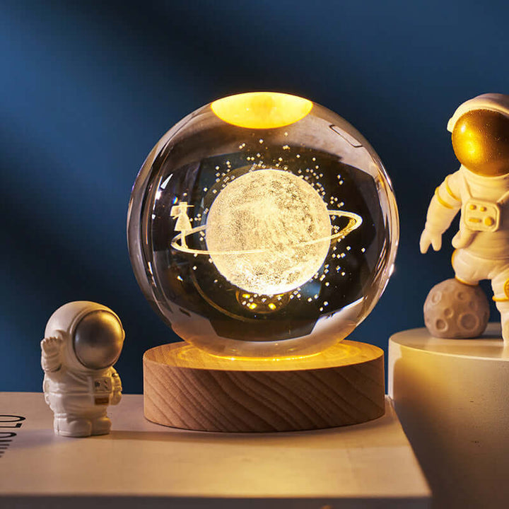 Luminous Starry Sky Crystal Ball Night Lamp with 3D Planetary Projection, featuring Saturn and cosmic design elements, on wood base.