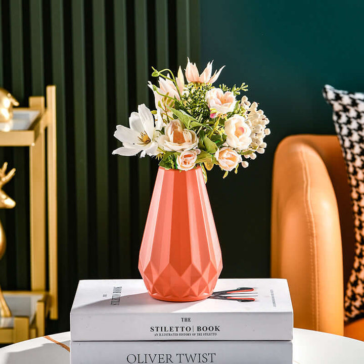 Nordic style color vase with floral arrangement on books, featuring a modern geometric design; ideal for Japandi and biophilic decor.