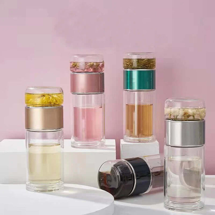 Stylish glass tea infuser bottles with built-in filter, perfect for brewing loose-leaf tea, featuring durable borosilicate glass and stainless steel.