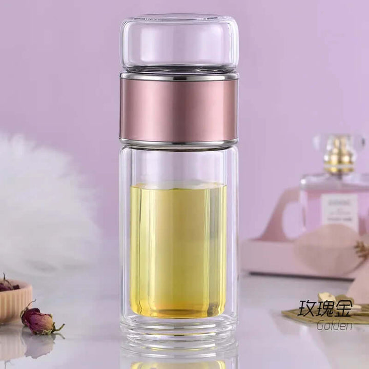 Glass tea infuser bottle with built-in filter and double-layer design for hot or cold beverages, perfect for on-the-go tea lovers.