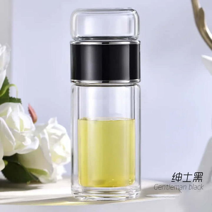 Glass tea infuser bottle with built-in stainless-steel filter, elegant double-layer design, and stylish black band for travel and home use.