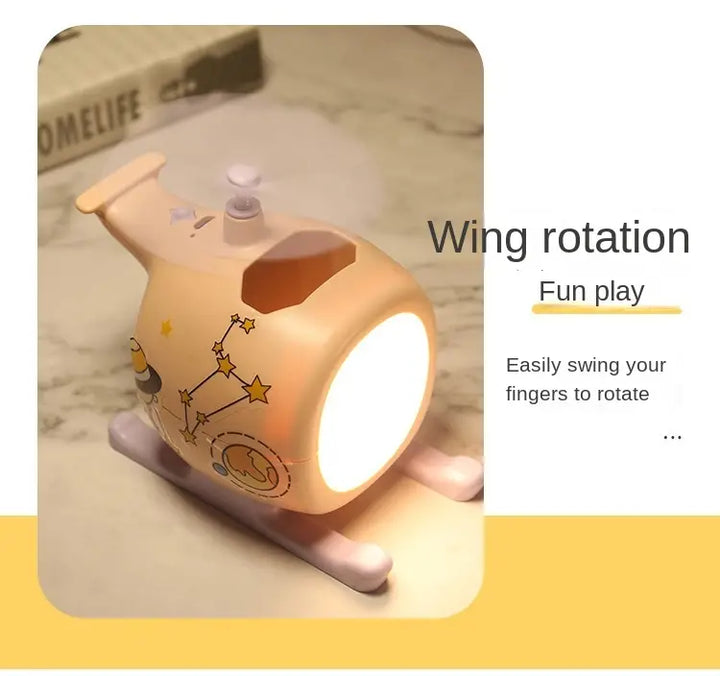 Airplane-shaped USB rechargeable night light with rotating wings, featuring warm LED glow, suitable for kids' rooms or desks.