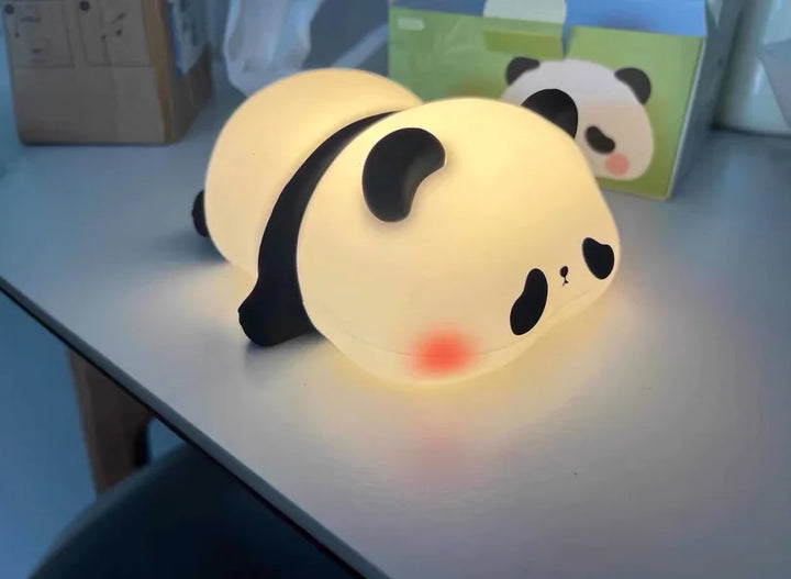 Cute panda silicone LED night light on table, glowing softly, ideal for kids' room decor.