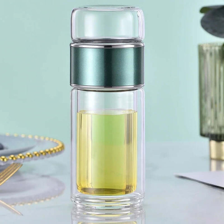 Glass tea infuser bottle with built-in filter, perfect for brewing tea on-the-go. Double-layer design for heat protection.