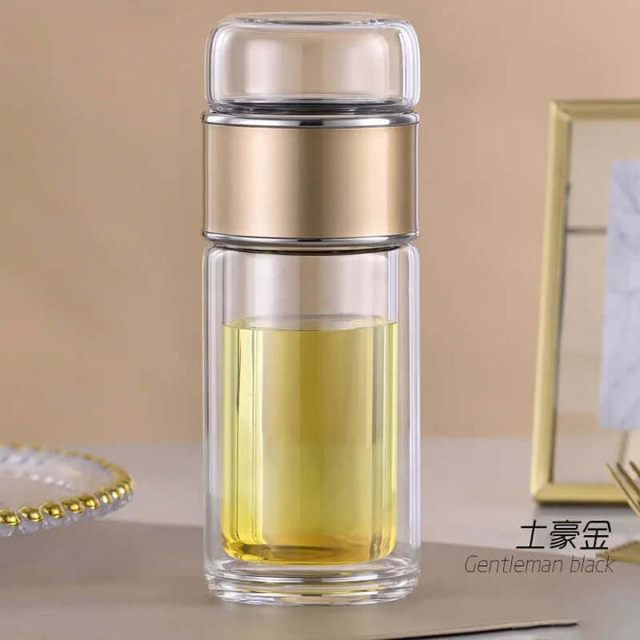 Tea Infuser Bottle with built-in filter, glass tumbler for fresh brewed tea, stylish home accessory.